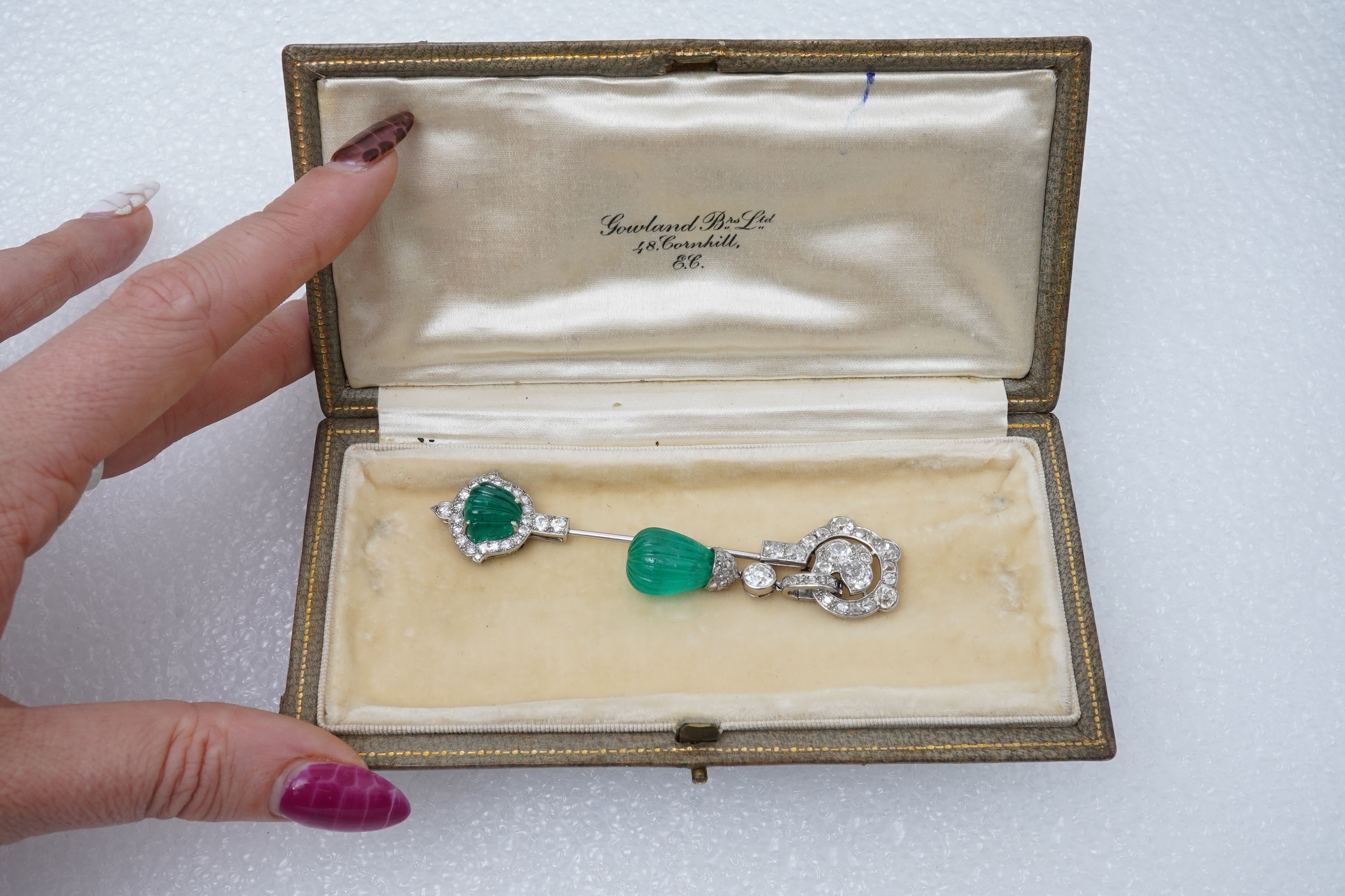 A fine Art Deco carved emerald and diamond jabot pin, circa 1925